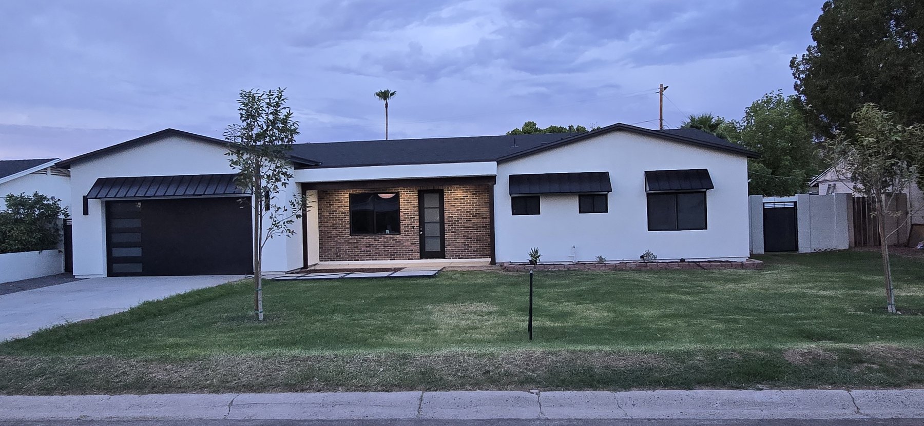 Real photo of front exterior at dusk, medium distance