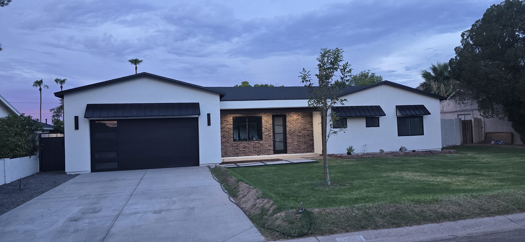 Real photo of front exterior at dusk, close angle