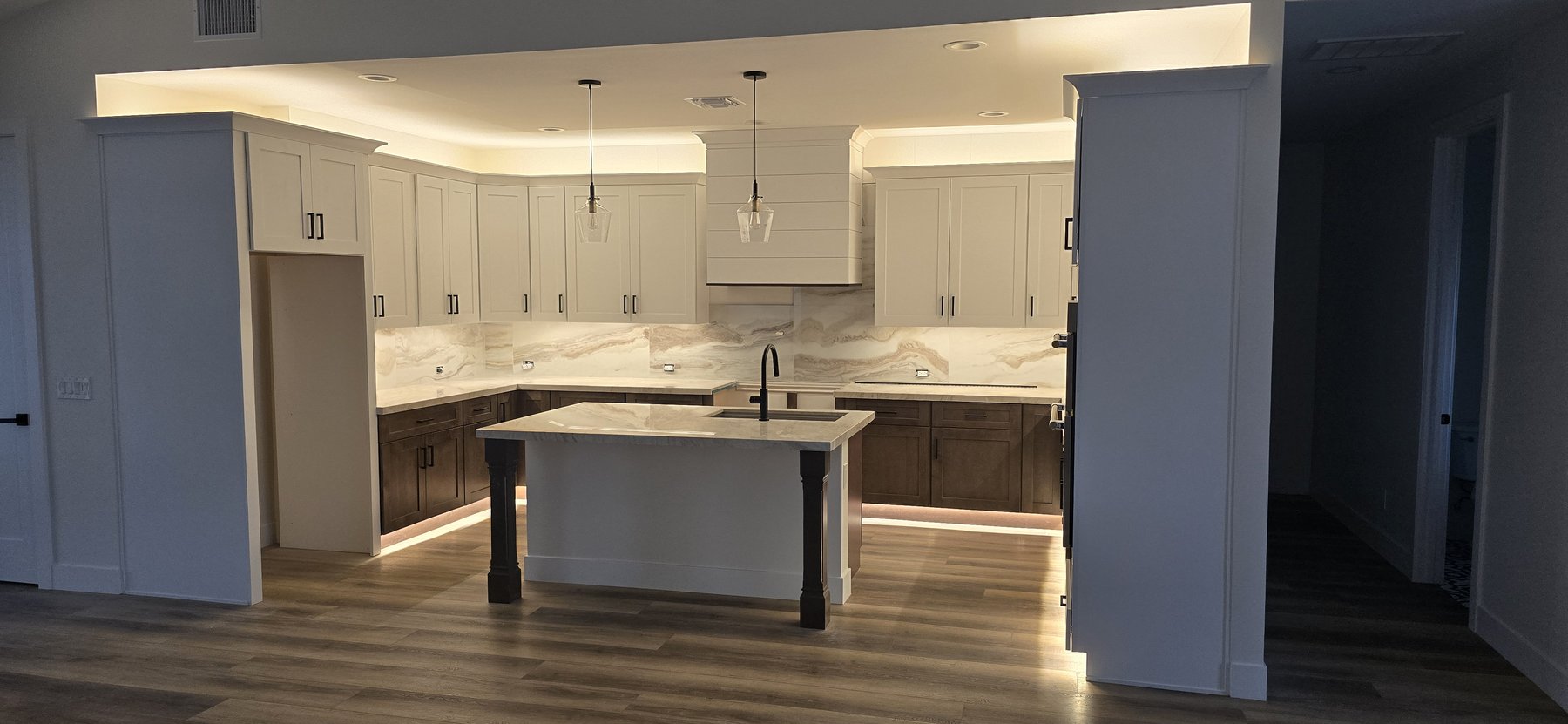 Real photo of completed kitchen with island and quartzite backsplash