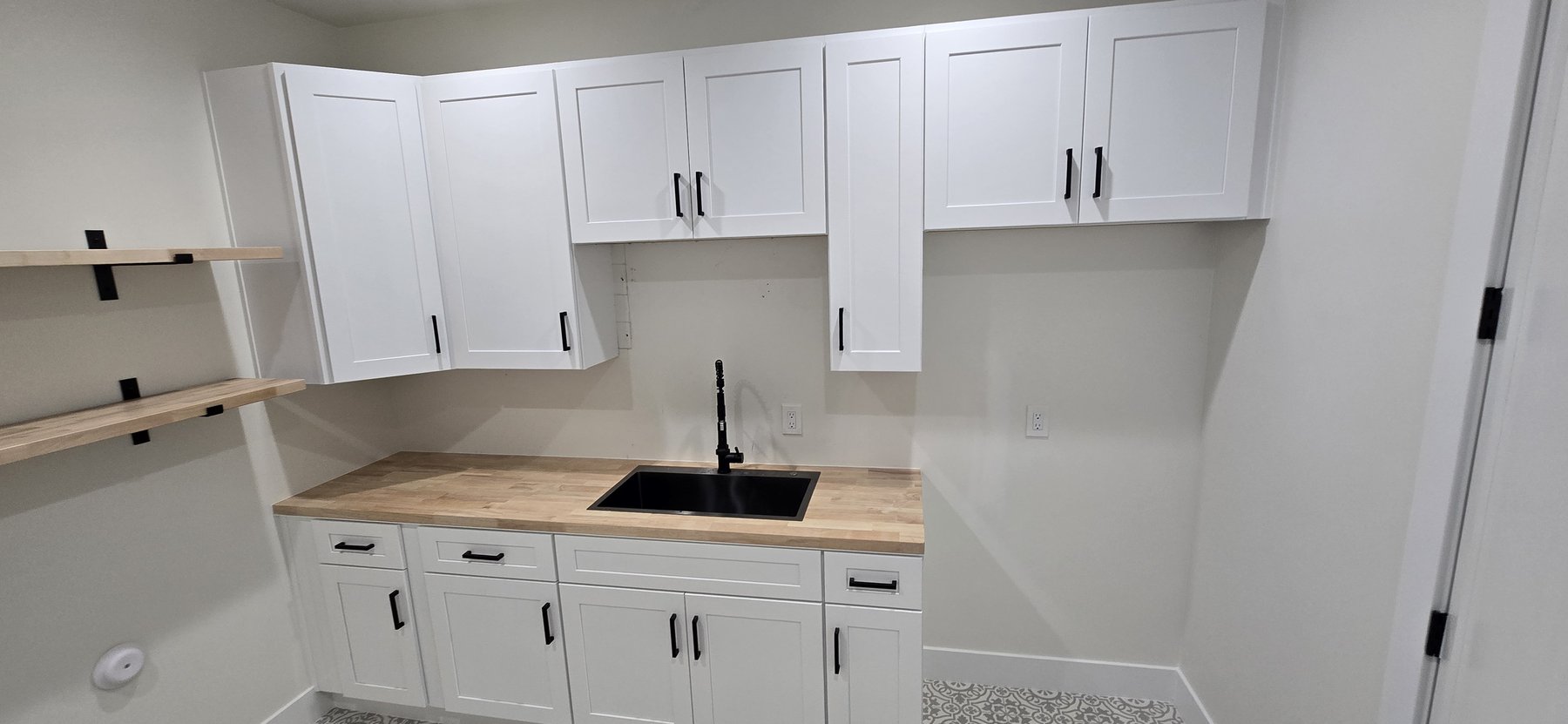 Real photo of laundry room sink and cabinetry