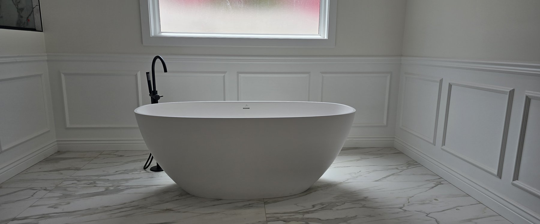 Real photo of completed primary bathroom soaking tub