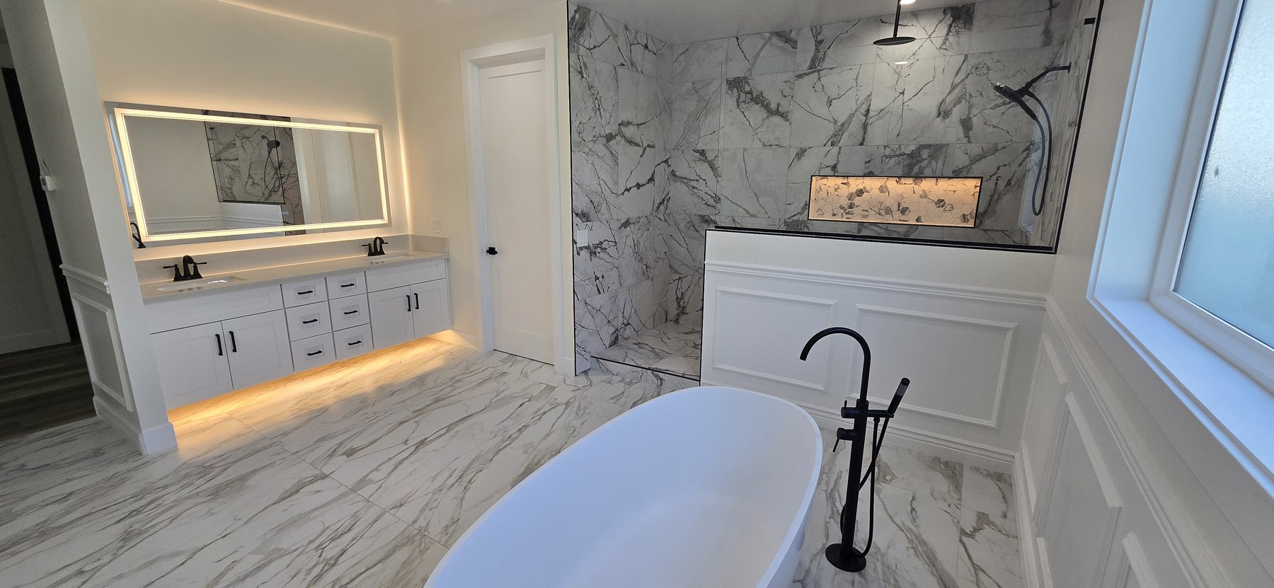 Real photo of primary bathroom with soaking tub and shower